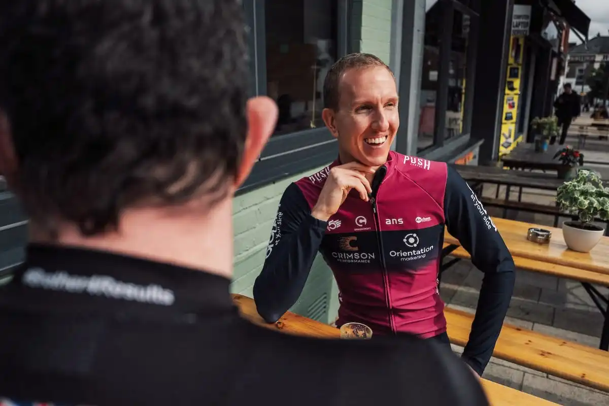 Matt Hallam owner and manager of Crimson Performance talking to Phil Jones MBE outside a cafe