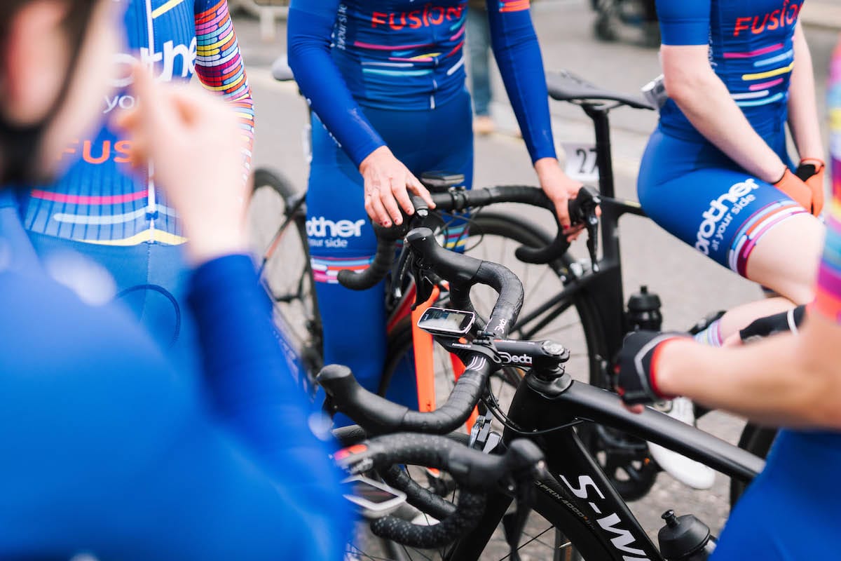 Cyclists wearing Brother UK-FusionRT team colours gathered together on bikes