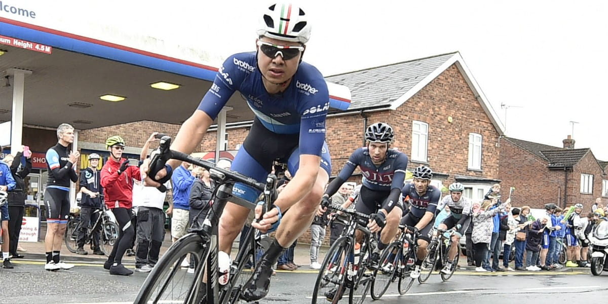 cyclists lean into corner
