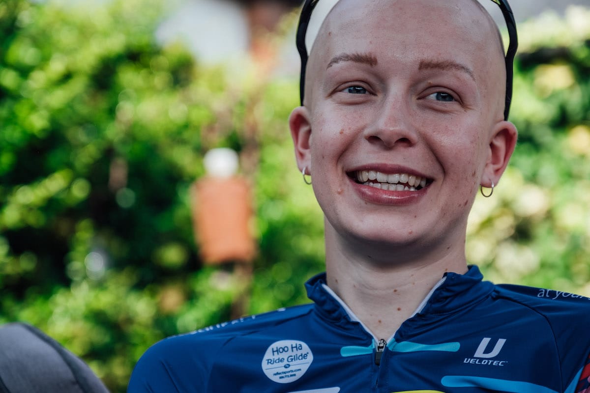 Cyclist Molly Patch smiling with greenery in the background