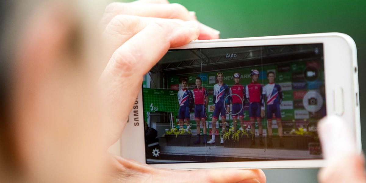 photograph of someone taking a snap of the podium on their smartphone