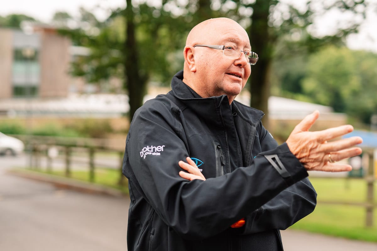 Tony Barry gesturing while talking to someone off-camera