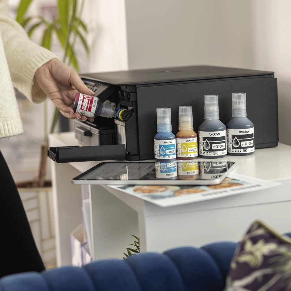 <p>DCPT530DW ink tank being filled with magenta bottle</p>
