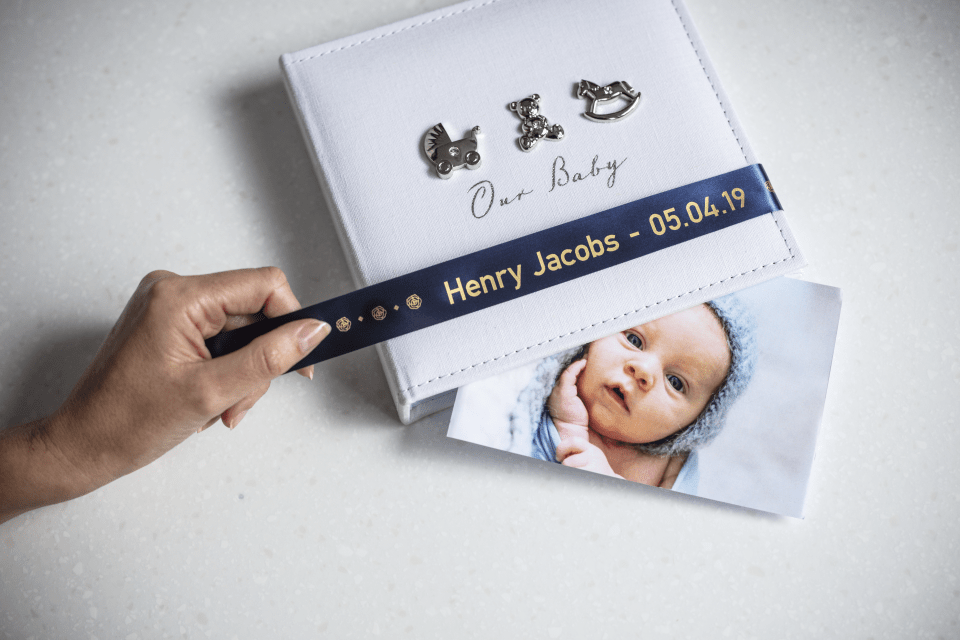 Brother TZe-RN54 satin ribbon tape cassette - gold on navy blue - new born baby photo album with the name and date of birth of the baby
