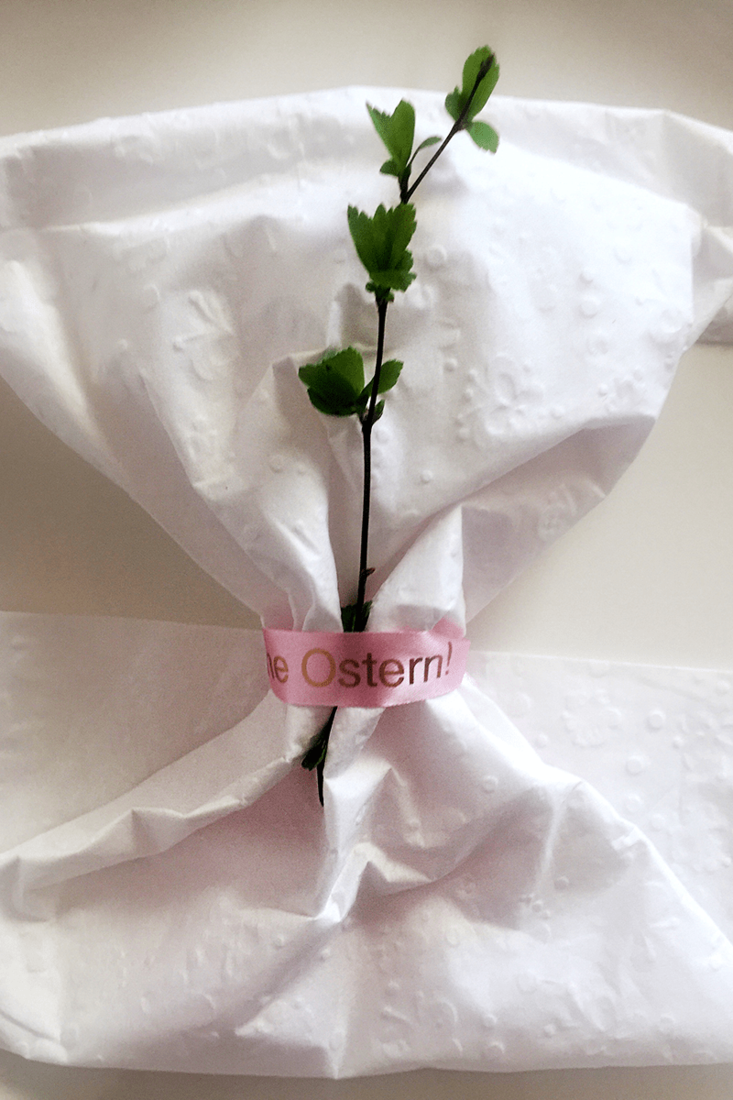 Brother TZe-RE34 satin ribbon tape cassette - gold on pink - table napkin and sprig of foliage wrapped in a personalised ribbon