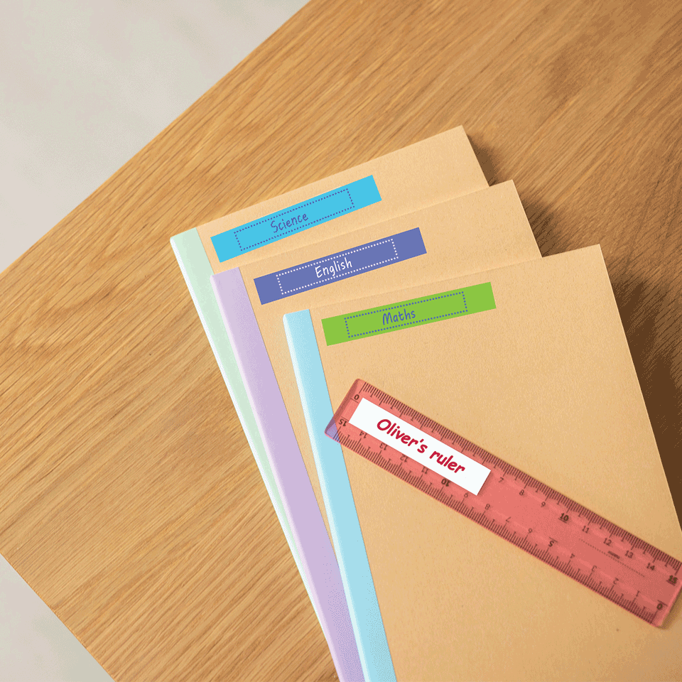 <p>School text books and ruler labelled with various coloured Btag tapes</p>