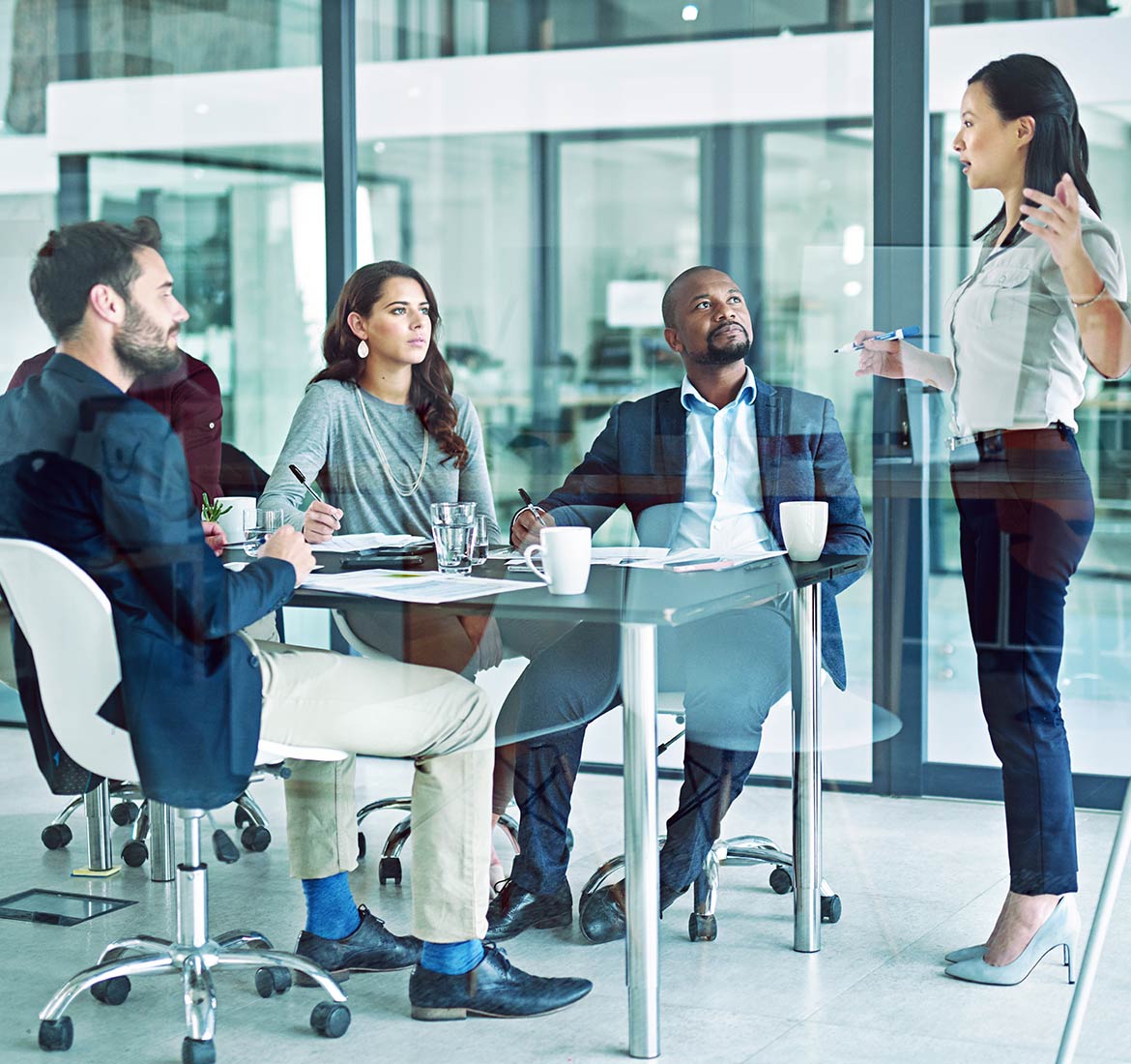 IT team discussing business transformation in a corporate office setting