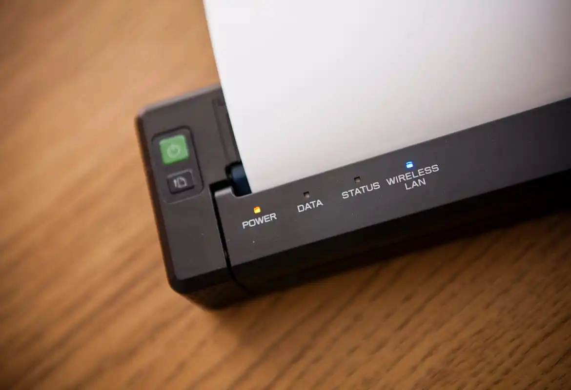 Close-up of a Brother PJ Series tattoo printer on a wooden surface