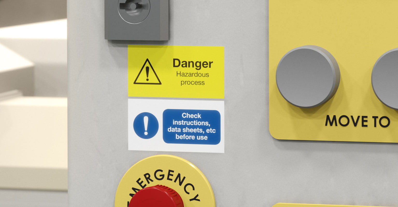 Two Brother P-touch labels on a control panel, warning of danger and to check instructions before use