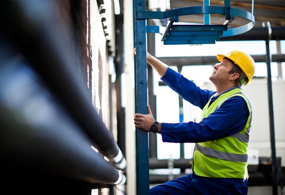 Gentleman climbing a ladder in a warehouse