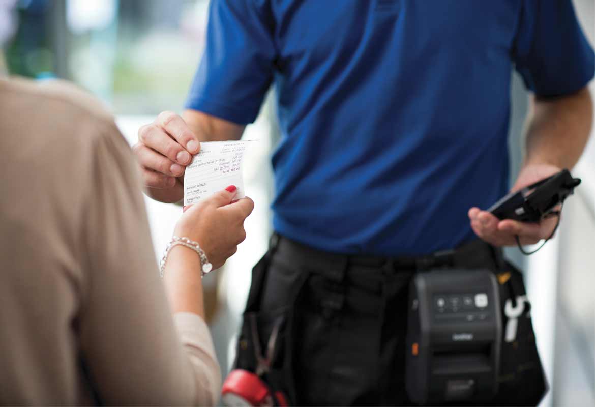 Man handing over a receipt printed from a Brother mobile printer