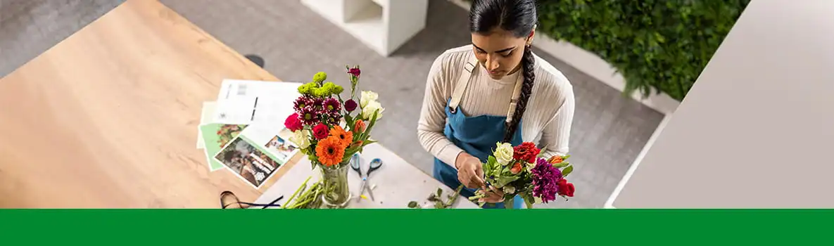 Female florist, table, flowers, colour documents