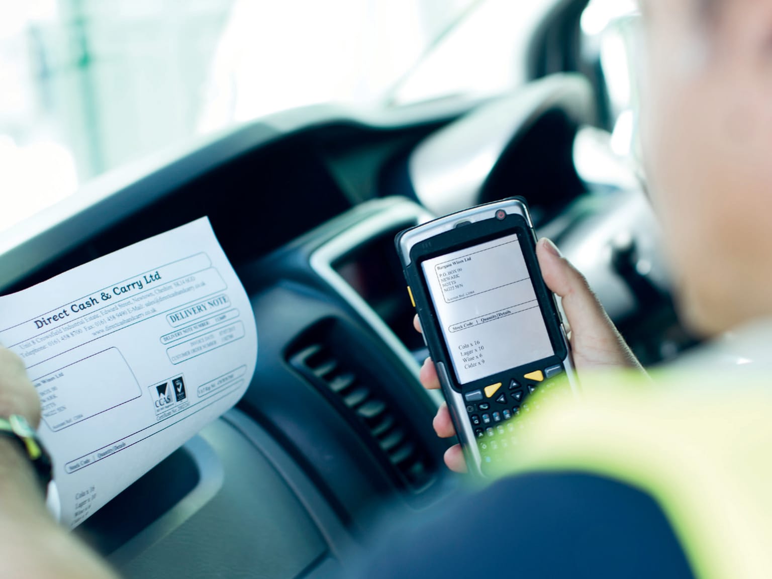 A Viaport employee printing a customer delivery note on a Brother PJ-763MFi A4 mobile printer in the cab of his truck