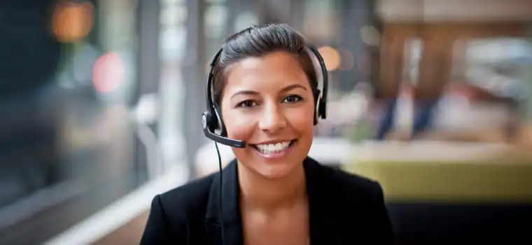 Woman with hair tied back sat with a headset on head