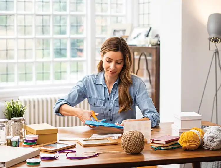 Woman sat at hoe office desk - using arts ad crafts