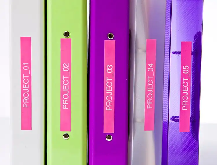 grey, green, purple, transparent grey, and transparent purple folders, on a shelf