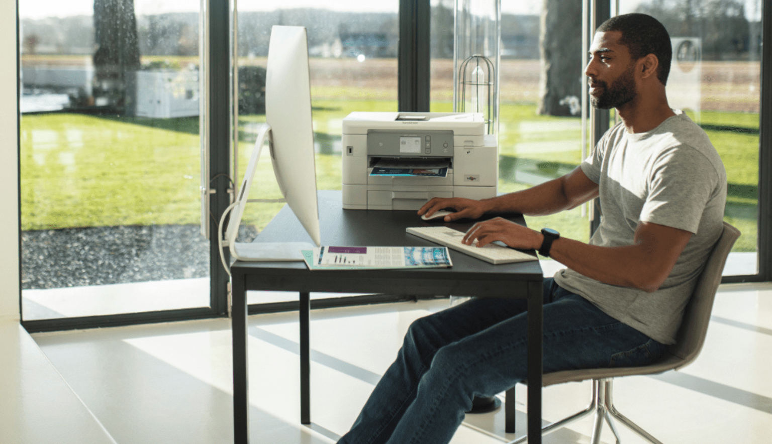 Man at home scanning documents using a brother device