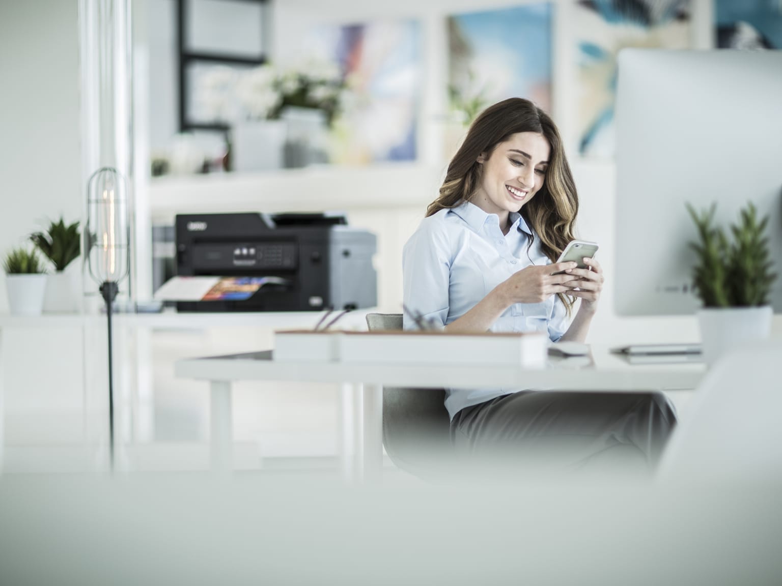 A lady printing a document from a smartphone in a home office environment