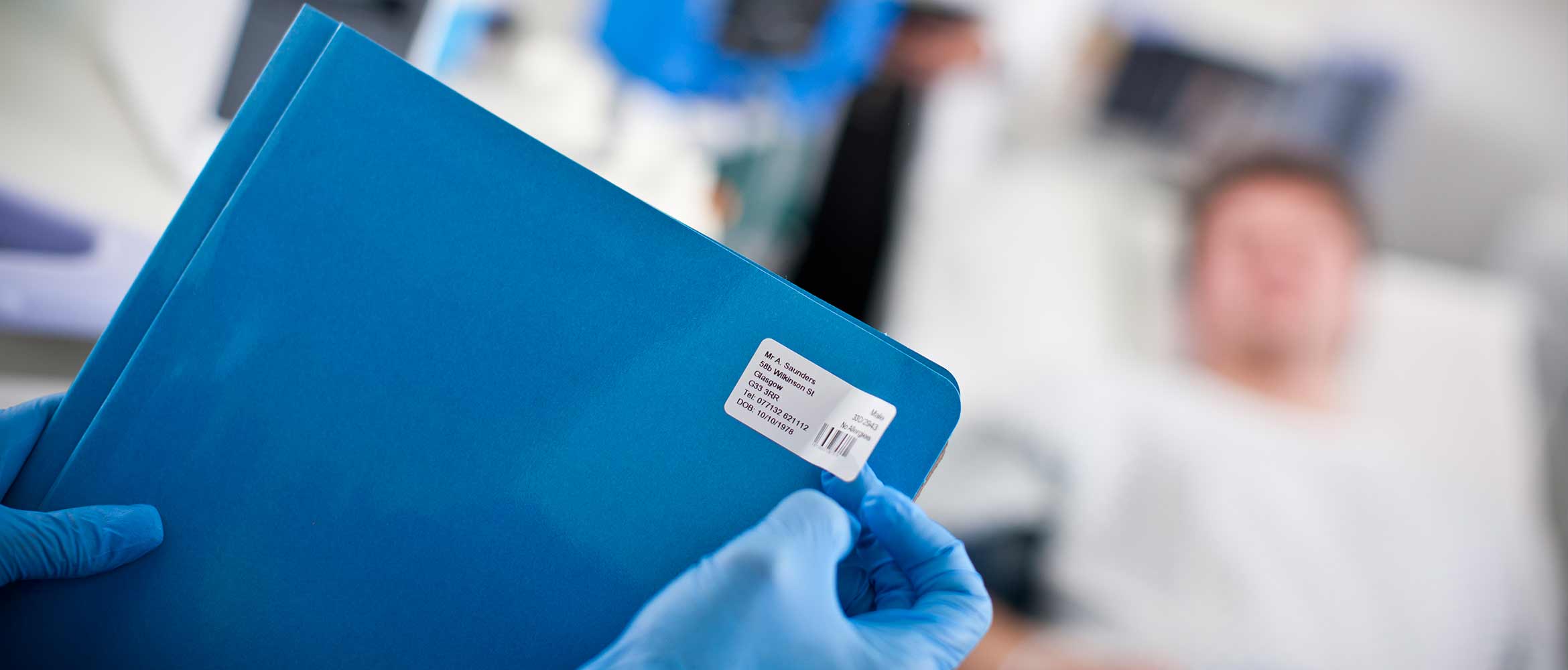 a blue patient folder clearly labelled with patient information