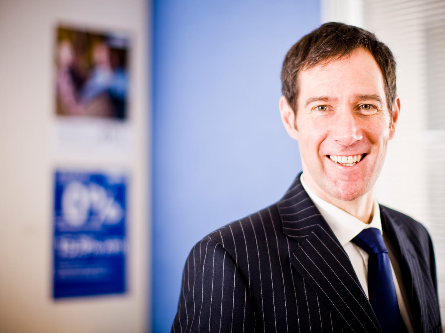 Man in striped suit smiling