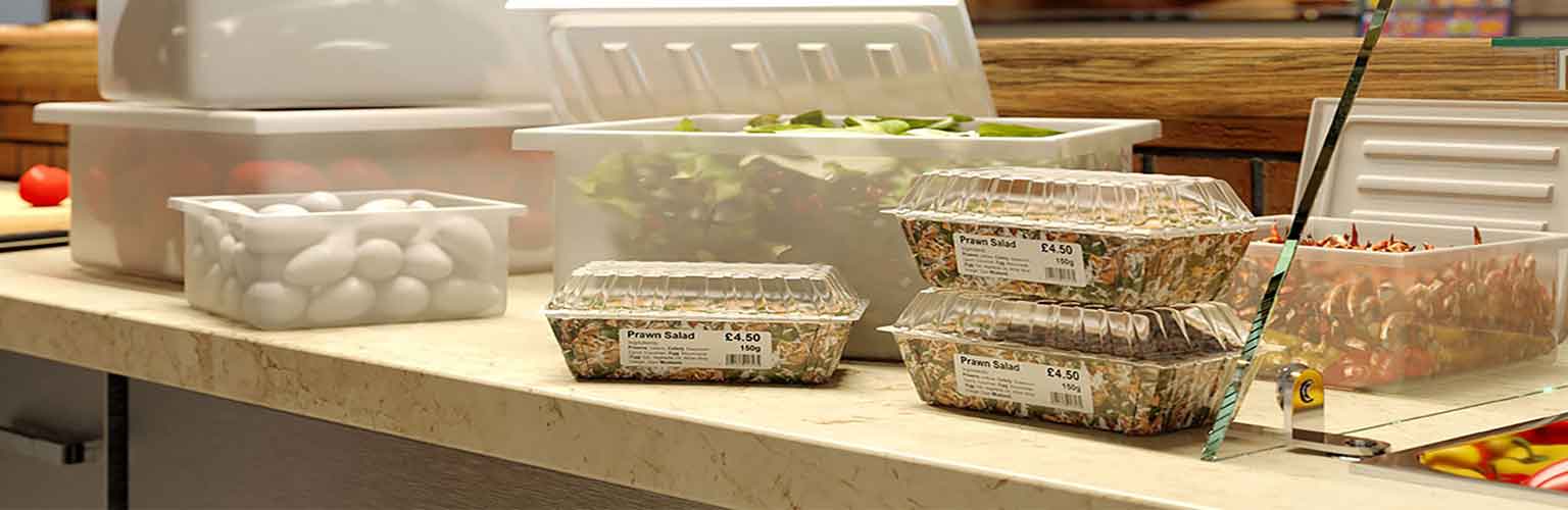 A kitchen worktop with plastic food packaging labelled using a Brother machine