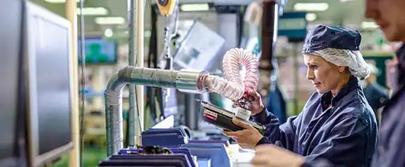 Brother recycling factory worker testing empty toners ready to be refurbished