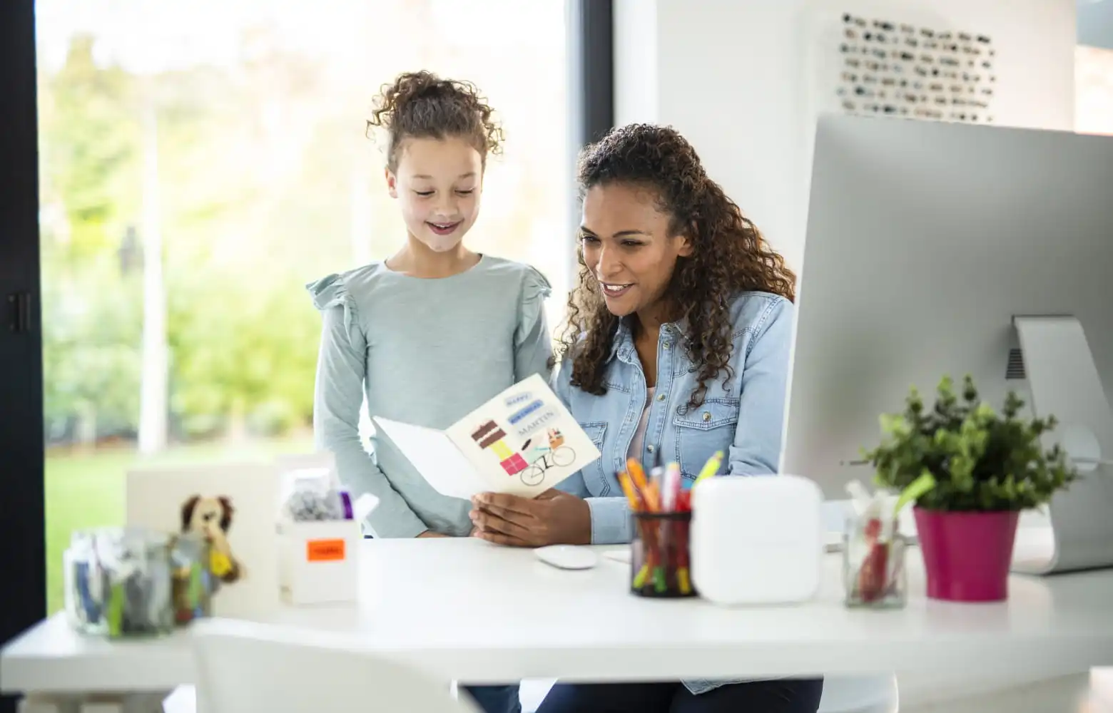 Mother and daughter creating a personalised card using a Brother P-touch label printer