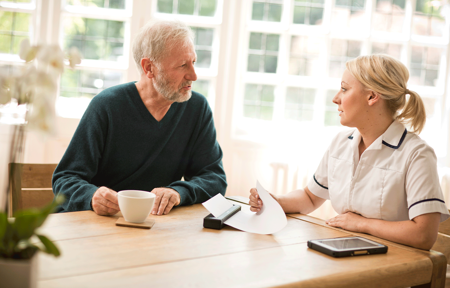 Man and woman community healthcare pj printer printing on wooden table