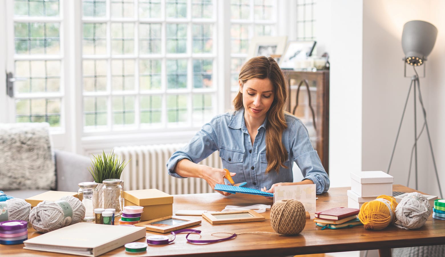 Woman sat at home office desk using arts and crafts